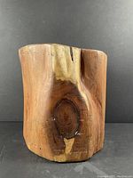 Front view of live wood stool showing prominent wood grain and knots with natural imperfections