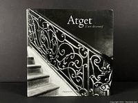 Front cover of the hardcover book showing a black and white photo of an ornate iron staircase railing, title 'Atget L'art décoratif' and publisher Flammarion.
