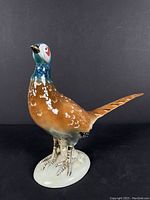 Front and right side angled view of the Royal Dux porcelain pheasant sculpture showing detailed painting and base.