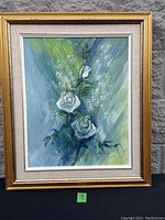 Full view of the framed painting of three white roses with signature and date visible near bottom left corner.