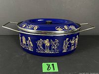 Front and top angle view of the blue enameled Dutch oven with Asian-inspired design on a neutral background.