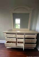 Front view of dresser with most drawers open showcasing storage space