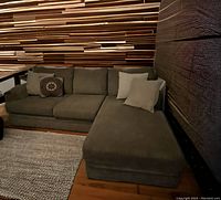 Photo of light brown chaise sectional sofa with cushions and pillows showing overall style and condition.