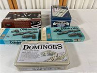 Five domino sets in their original boxes arranged together on a surface.