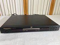 Full front view of the black Marantz DVD player showing the power button, display, and DVD tray.