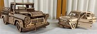 Both wooden Ugears vehicle models, truck on left and station wagon on right, showing overall size and design