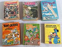 Overview of six vintage Big Little Books from the 1960s-80s by Whitman Publishing including Lone Ranger, Lassie, Flipper, two Tom and Jerry books, and Huckleberry Hound.