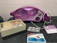 View of the purple Easy Bake Oven with mixes and accessories in front