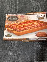 Box front showing Gotham Steel Bacon Bonanza copper bakeware with wire rack and cooked bacon strips.