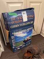 Original box of North 49 queen size air mattress with built-in foot pump, showing branding and product image.