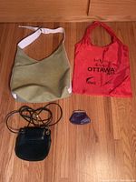 Overview of four items: faux leather tote, red nylon tote, small black handbag, small purple coin purse