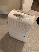 Image of the front and side view of the white Commercial Cool CK50E dehumidifier showing vent grill and logo.