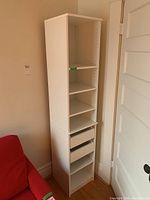 Front angle showing full shelving unit with adjustable shelves and two drawers.