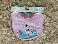 Pink baby's bib with embroidered snowman design, new with tag and price sticker