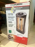 Damaged retail box of a Profusion Infrared Quartz Heater showing key features and an image of the heater.