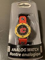 Front view of the kids analog watch in original packaging highlighting Calgary Flames logo on dial and strap.