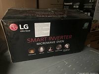 Box of LG Smart Inverter Microwave Oven with branding and features visible, showing stainless steel model with antibacterial EasyClean coating.