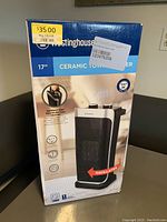 Front view of the Westinghouse ceramic tower heater box showing product image, features, and pricing sticker