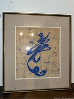 Full view of the framed batik art showing the entire piece and frame