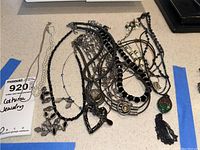 Photo showing a group of various costume jewelry necklaces laid out, highlighting different styles and materials.