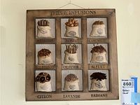 Full view of the wooden framed wall art with nine burlap bags labeled with different teas and infusions.