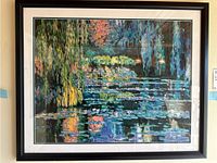 Framed impressionist water lilies print, showing the front view with visible signature and limited edition number.