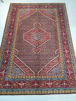 Full top view of rug showing central medallion, field pattern and border