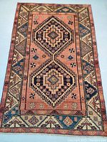 Full front view of the rectangular wool rug showing two central medallions and border