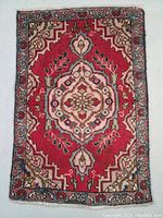 Full top view of the Persian Tabriz wool rug showing the red central medallion and floral border patterns.