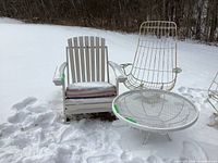 Overall view: Adirondack-style chair, metal scoop-style chair, and round mesh table arranged outdoors.