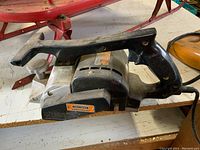 Craftsman electric planer on workbench showing side detail and label.