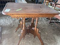 Overview of rectangular wood table top with scratches and rounded edges