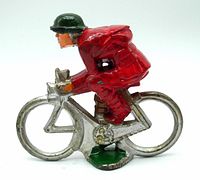 Side view of vintage cyclist figure showing red outfit and silver bicycle with green base