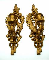 Front view of two vintage Burwood gold tone ornate candle wall sconces with leaf and floral designs.
