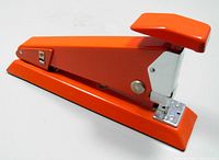 Side view of orange stapler showing overall design and color.