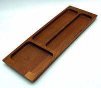 Top view of vintage wooden vanity tray showing three compartments for organizing small items.
