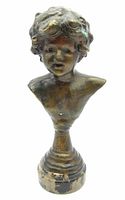 Front view of vintage bronze cherub bust with detailed facial features and curly hair, mounted on a marble base with visible wear and paint loss.