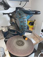 Front angled view of Rona double bevel mitre saw showing blade and handle