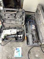 Ryobi reciprocating saw and Hauss Man impact drill in their respective cases, showing both tools and their general condition.