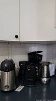 Photo showing Salton Cinema Popcorn Popper, Master Chef coffeemaker, and other small appliances on kitchen counter