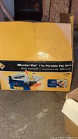 Boxed Master Cut 7-inch portable tile saw showing brand and model information on packaging.