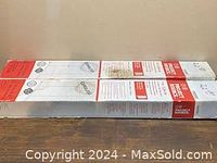 Two cordless window blinds in unopened boxes placed on table, viewed from the top.