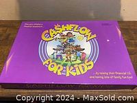 Purple game box labeled 'Cashflow for Kids' featuring cartoon illustrations, lying closed.