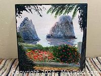 Full view of signed and certified oil painting of coastal scene with rock formations, water, and vegetation.