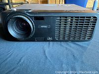 Front view of black Acer PD521 projector showing lens and ventilation grille.