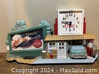 Front view of vintage Coca-Cola themed wall art with clock, gas pump, and car
