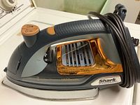 Side view of Shark professional iron showing power rating and brand details.