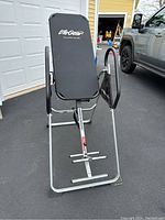 Front angle view of Life Gear inversion table showing padded black backrest, silver frame, and handles.