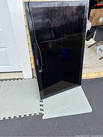 Front view of Samsung 46-inch plasma TV standing with cables visible along the side