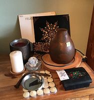 Photo showing whole lot on wooden surface including candles, lamp, wall art, acrylic decoration, box, nails, tealight candles.